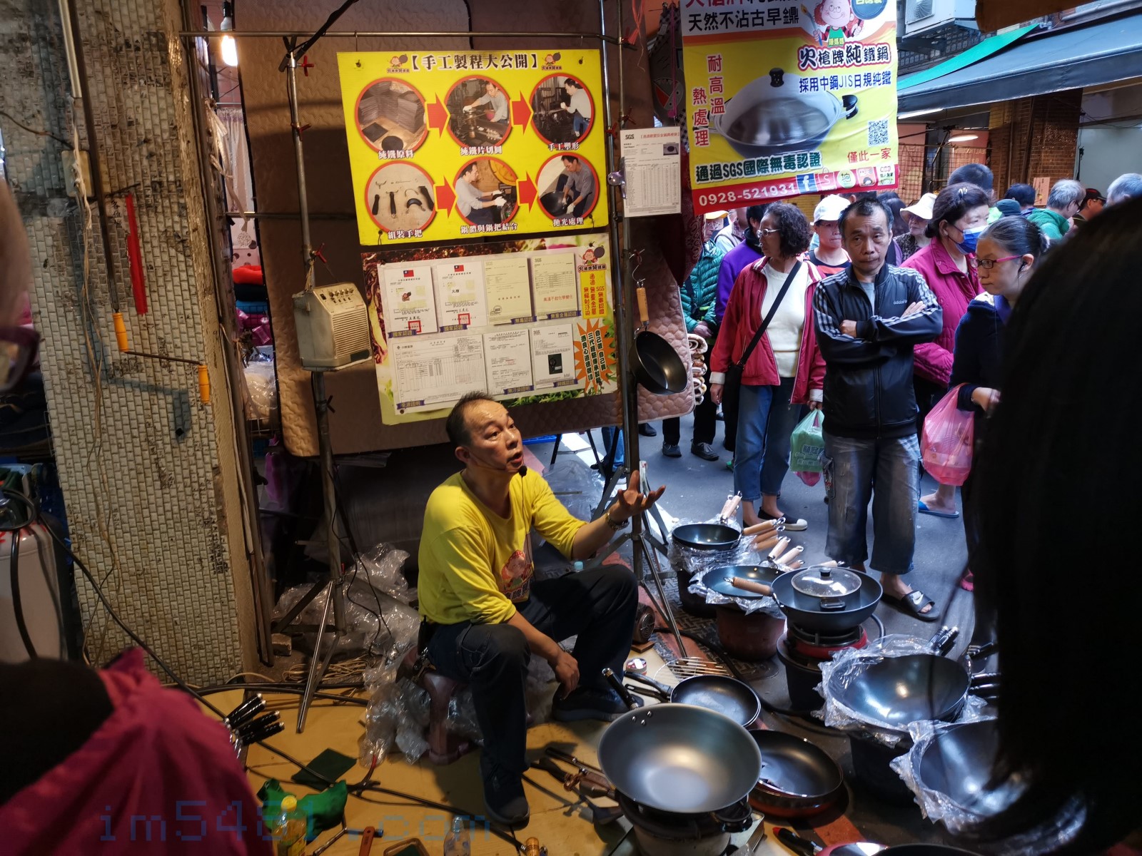 火槍牌鐵鍋在七堵市場的攤位，老闆正在解說產品。